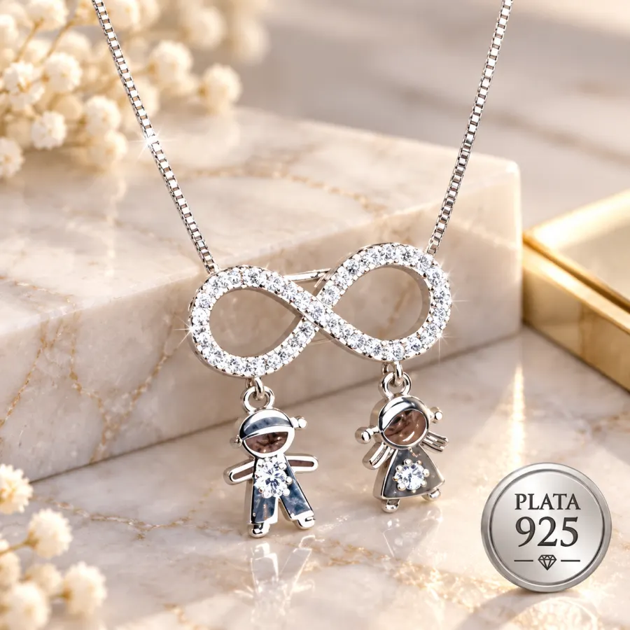 Collar infinito en plata 925 con circones y dijes de niño y niña sobre mármol